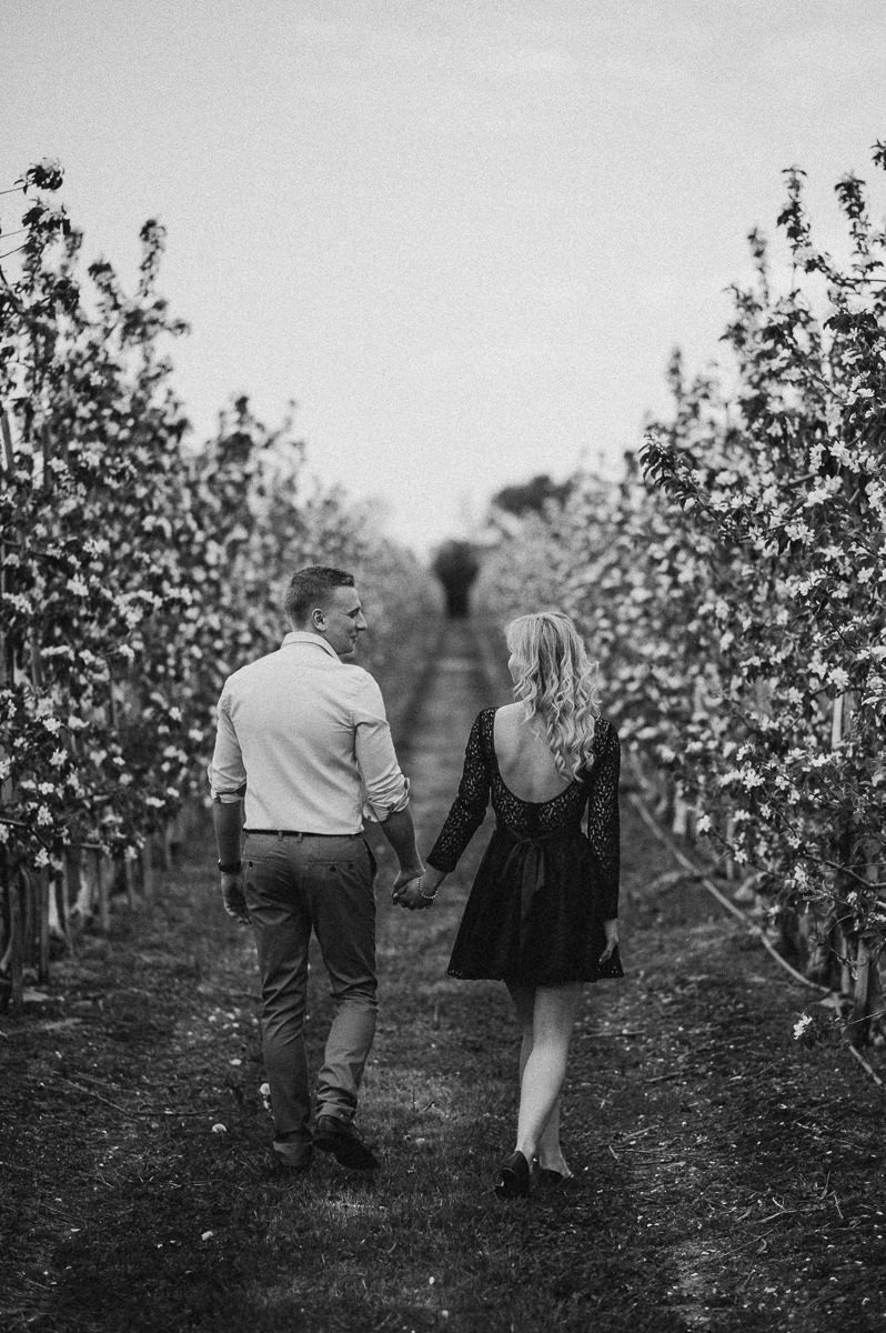 Para zakochanych spacerujaca w sadzie